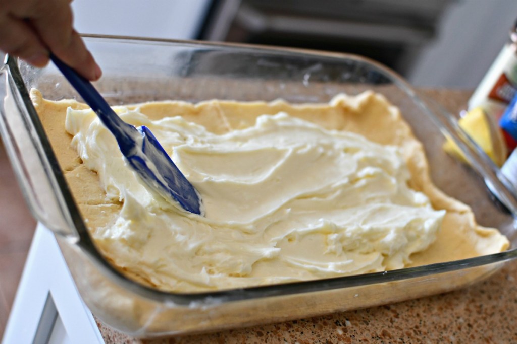 spreading cream cheese filling