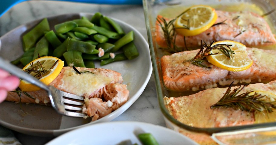 taking a bite of baked salmon