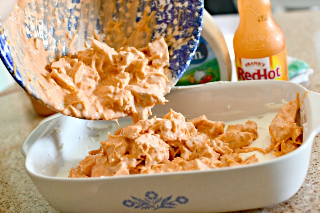 pouring dip into casserole dish