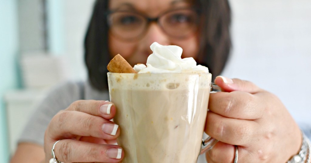 holding a cup of pumpkin spiced latte from the slow cooker