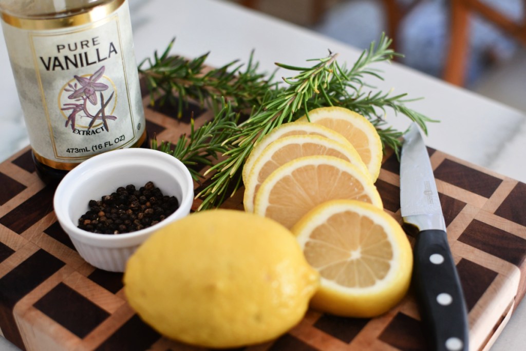 sliced lemons and rosemary on a cutting board