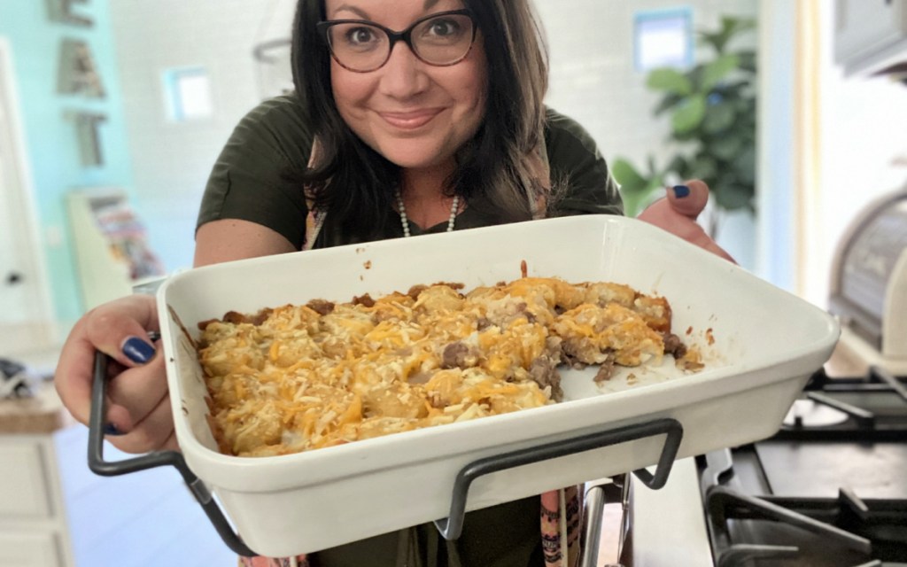 woman holding a tater tot casserole