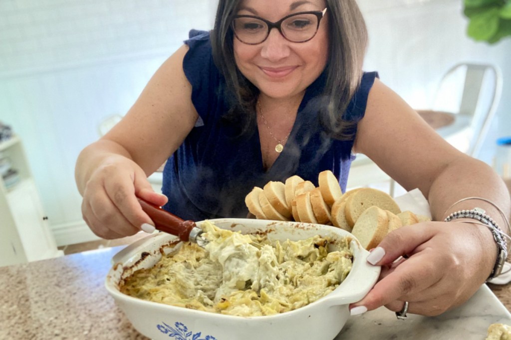 woman with artichoke cheese dip