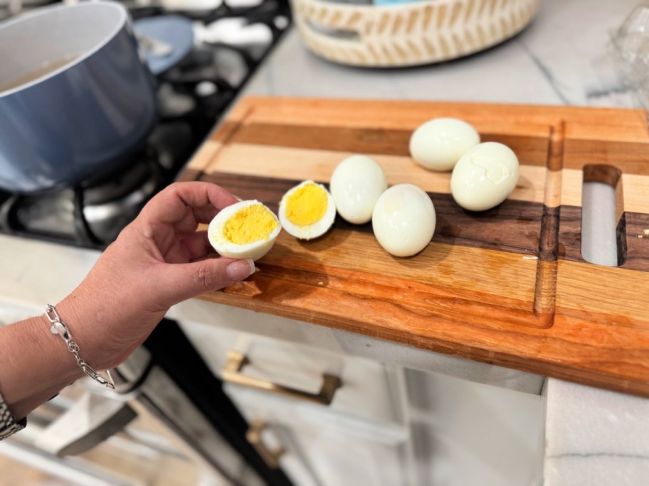 woman holding a hard-boiled egg cut in half