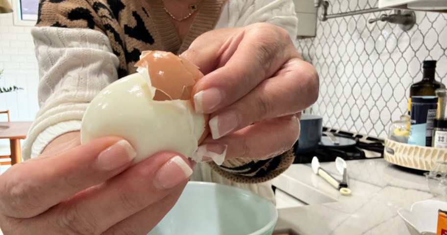 woman peeling hard-boiled eggs