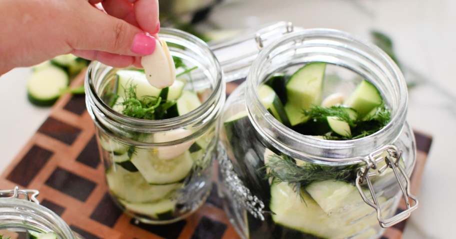 adding garlic to jars