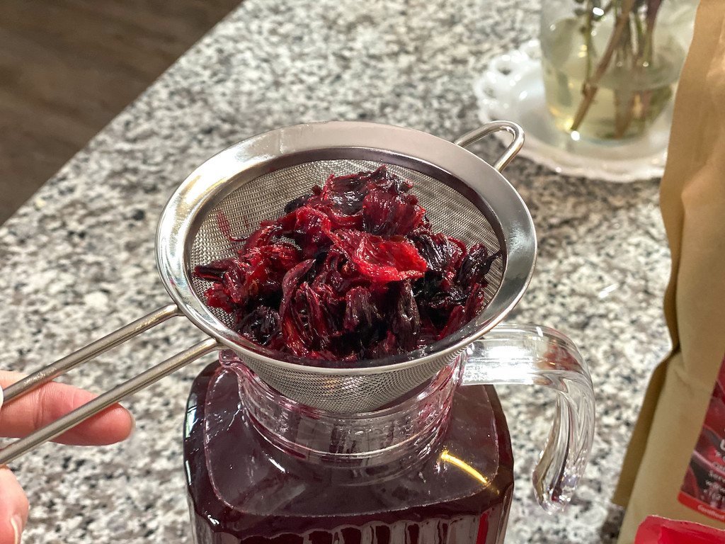 straining dried hibiscus flowers