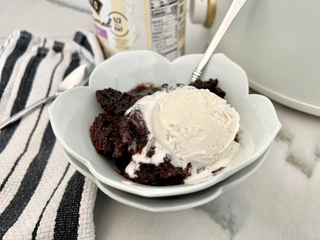 bowl of lava cake with vanilla ice cream scoop