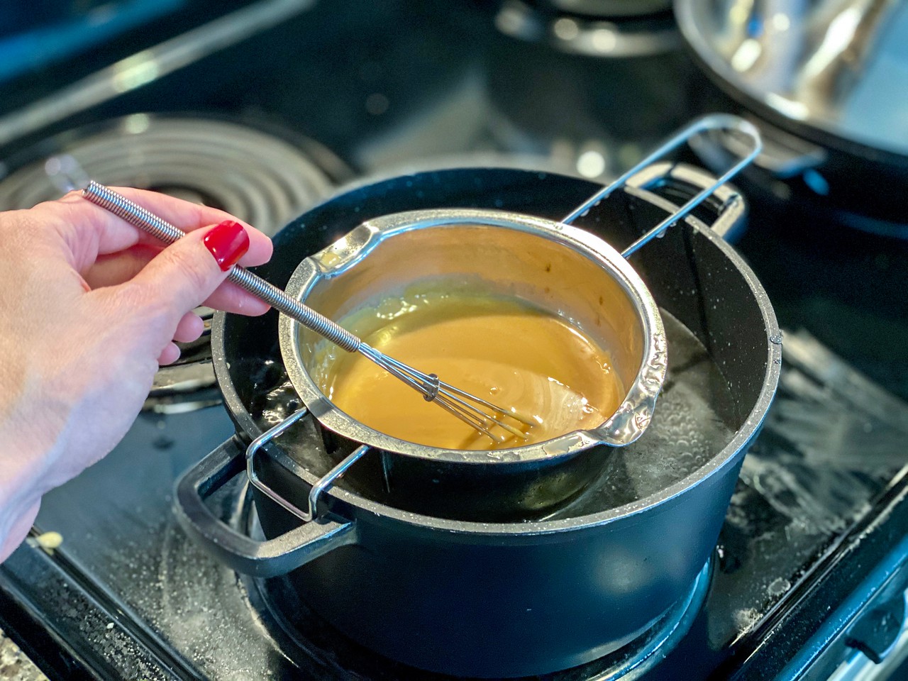 condensed milk in double boiler on stove