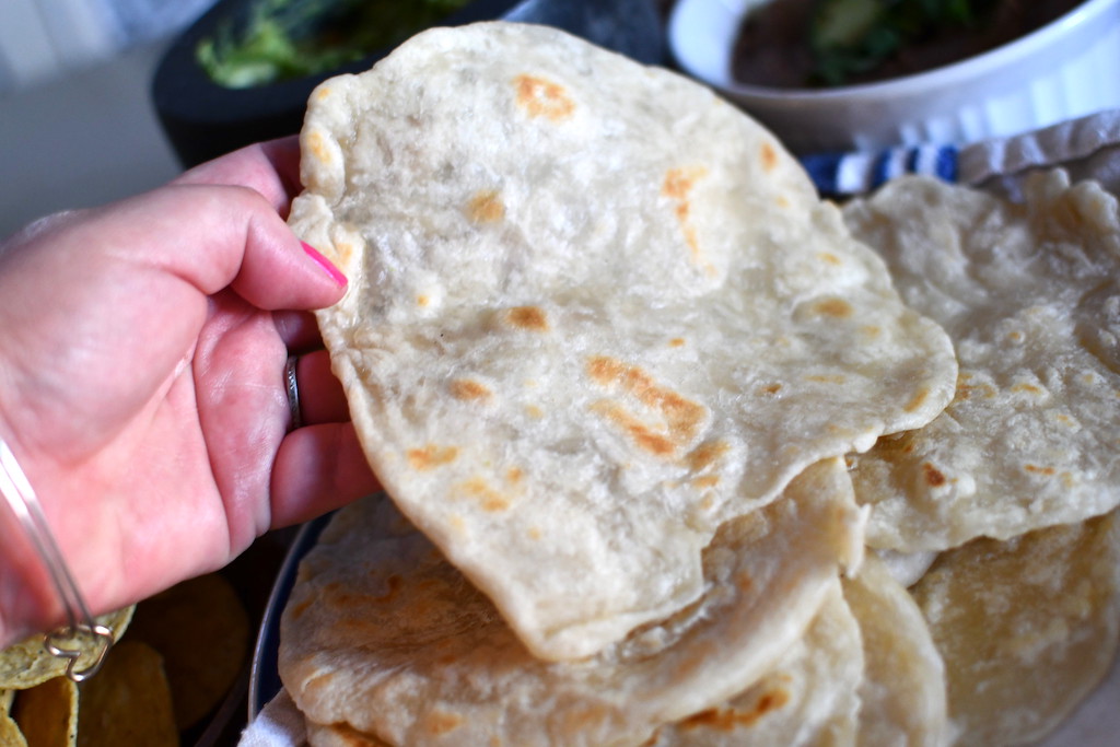 picking up homemade flour tortilla 