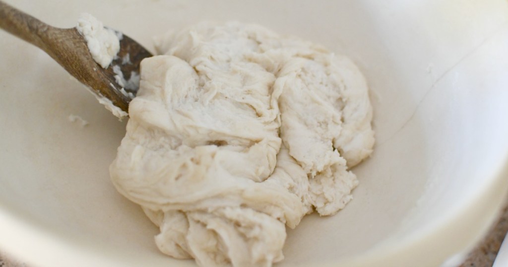 mixing tortilla dough in a bowl