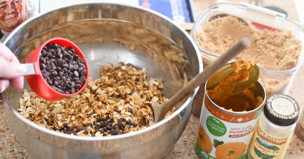 adding chocolate chips to pumpkin granola bars