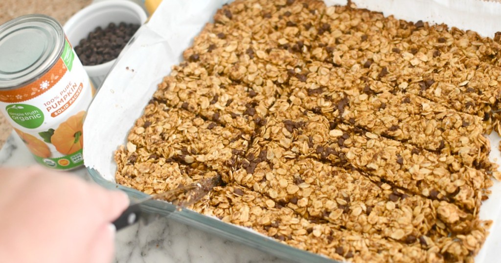 cutting a pan of pumpkin granola bars