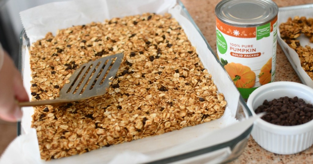 pressing granola bars into a pan