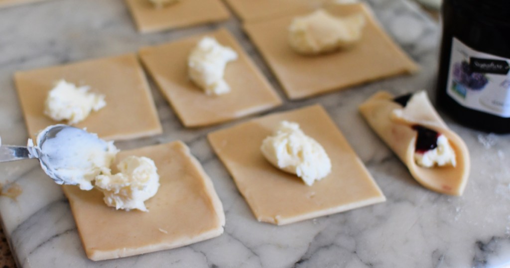 adding cream cheese to blackberry tarts