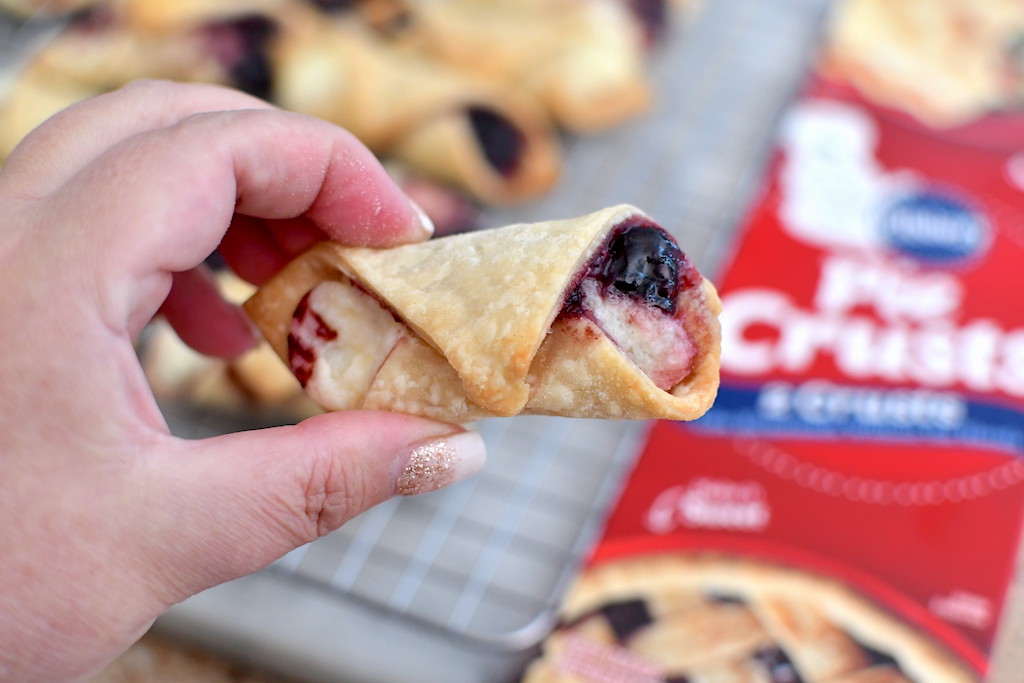 holding blackberry cream cheese tart