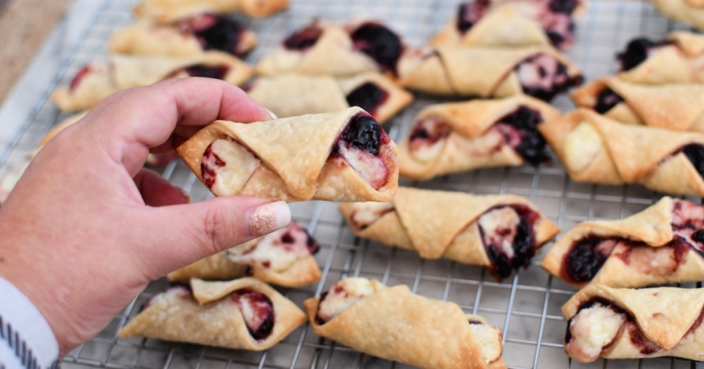 holding a blackberry tart