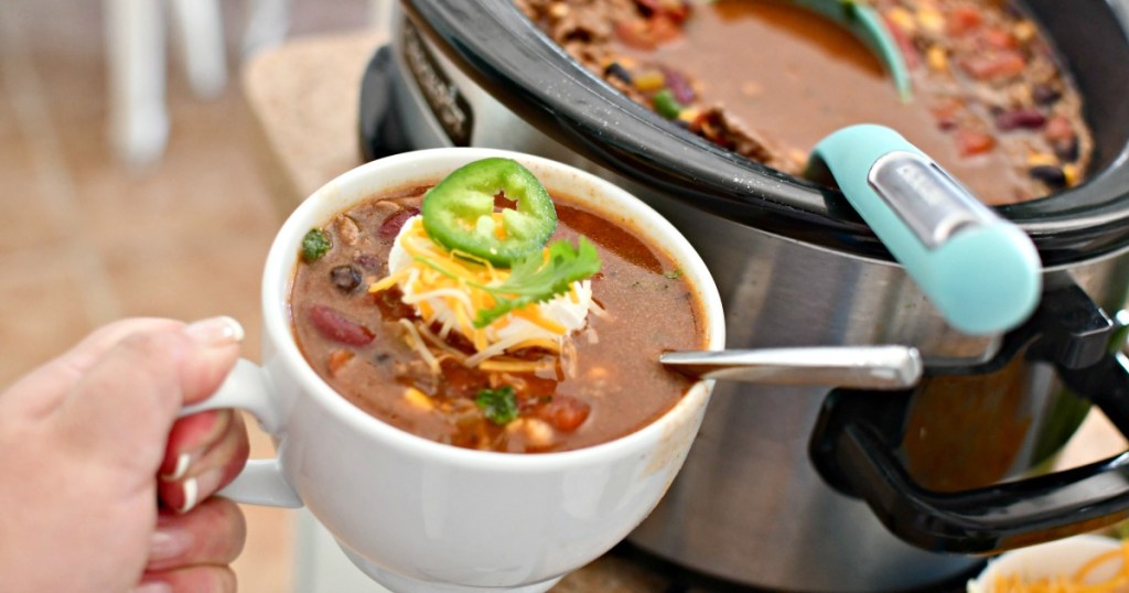 holding a cup of ranch taco soup