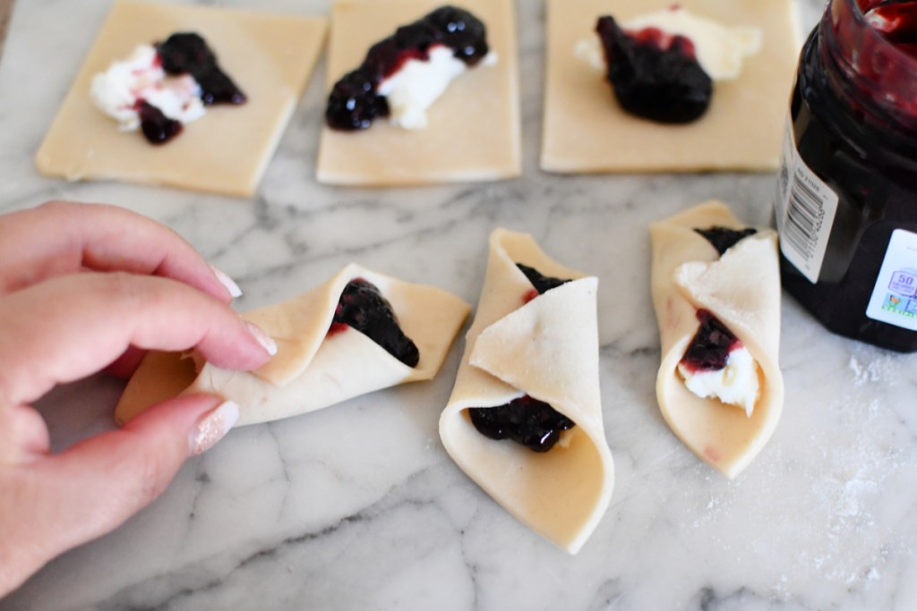 pinching blackberry tarts together