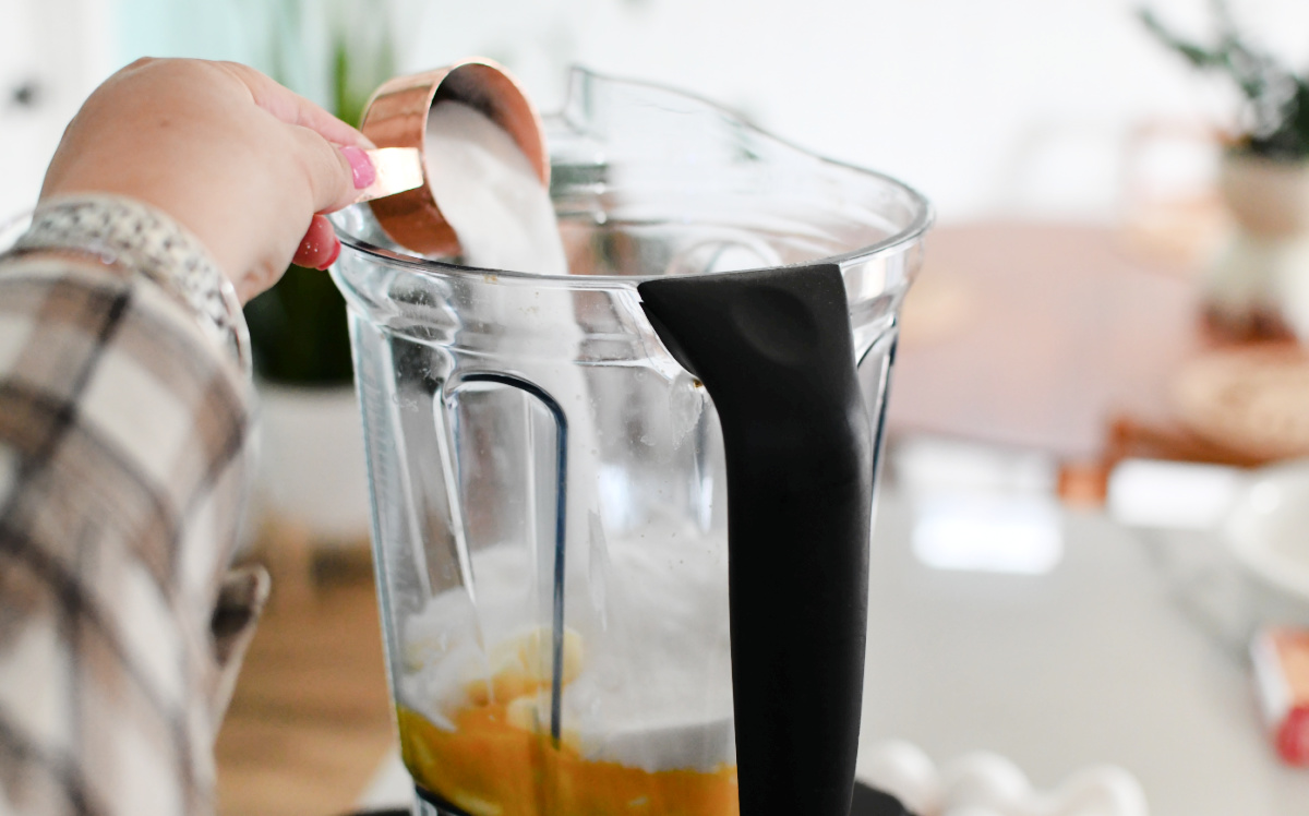 adding sugar to the blender