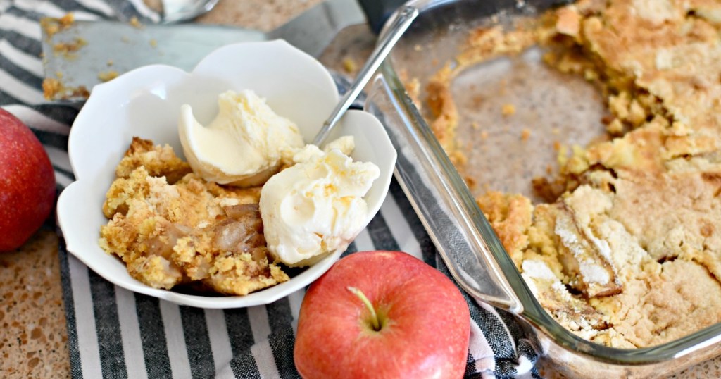 bowl of apple dump cake next to pan