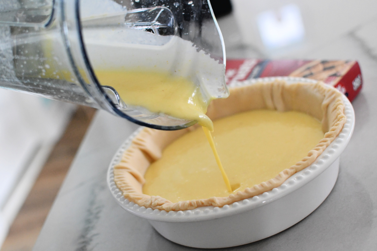 pouring lemon batter onto pie crust