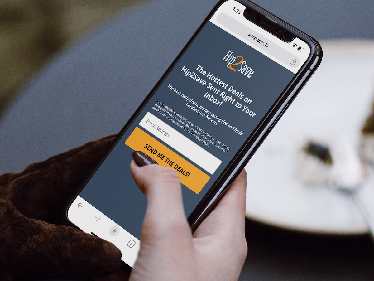 hand holding phone with email sign up for hip2save