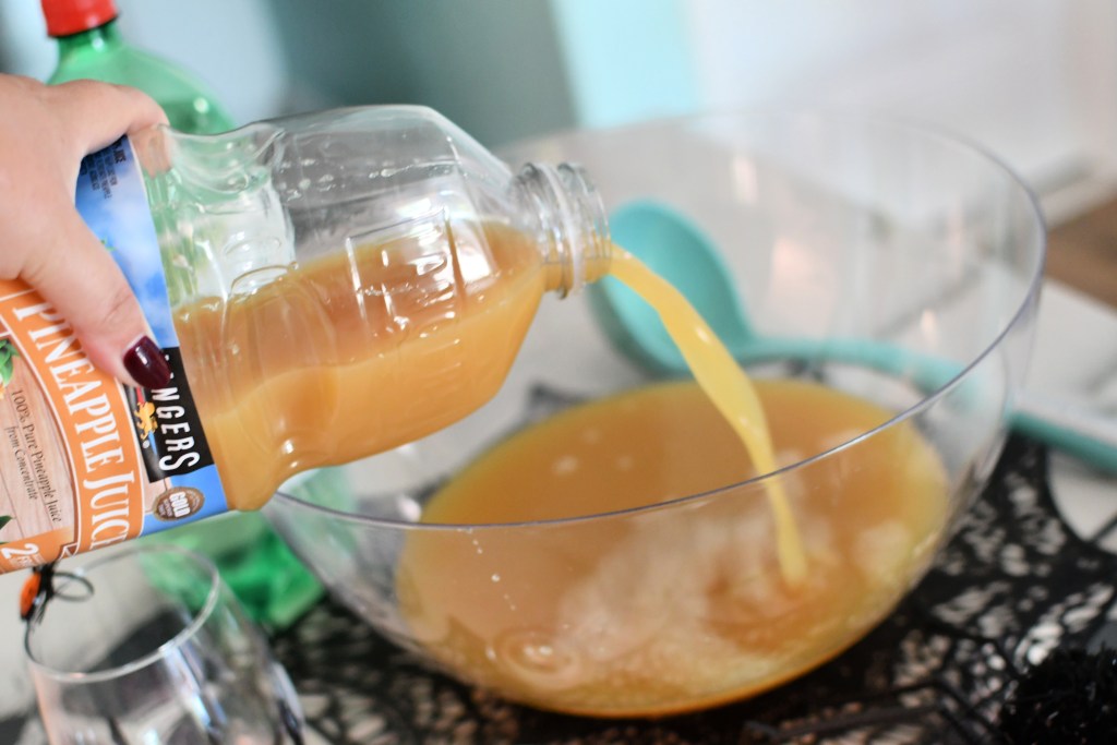 pouring in pineapple juice for punch