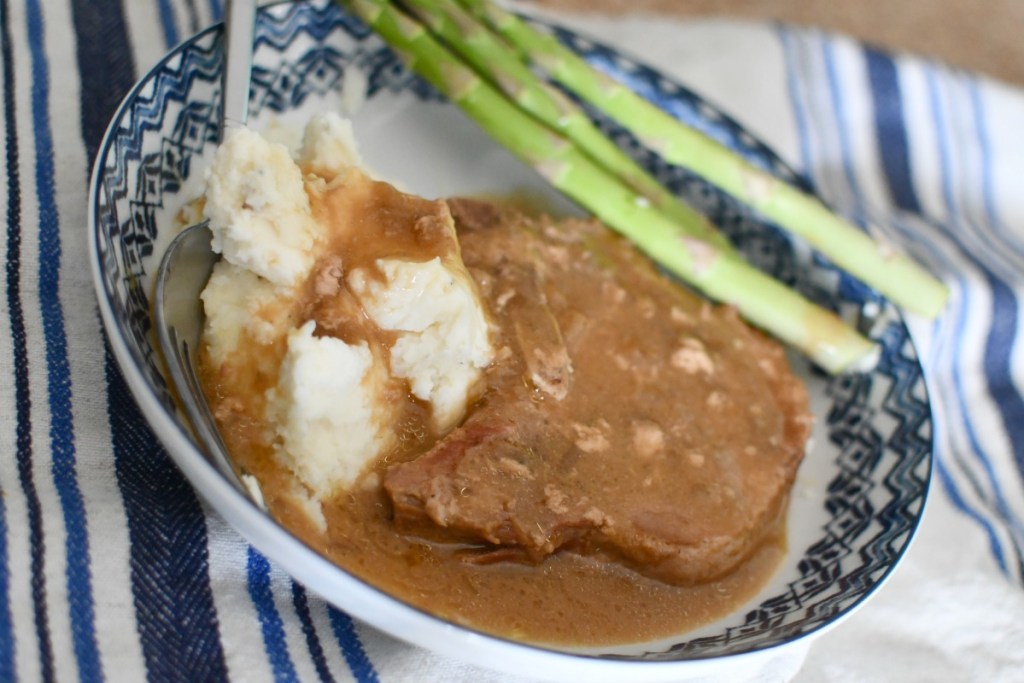 plate with slow cooker pork chops and mashed potatoes