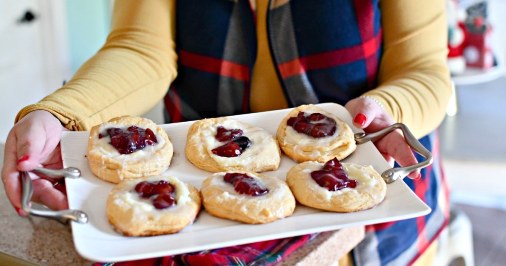 holding a tray of cream cheese cherry danish