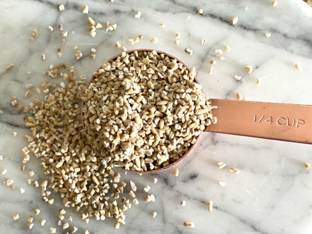 raw steel cut oats in a measuring cup 