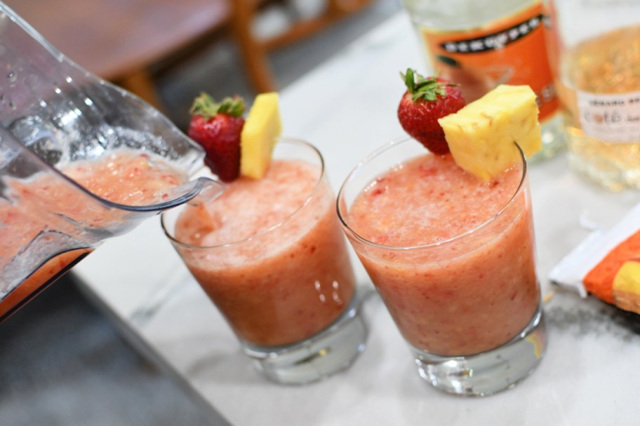 pouring frozen fruit wine drink in glass cups