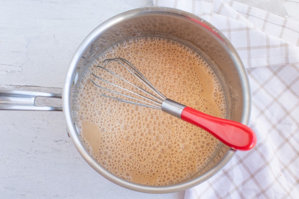 whisk in pumpkin spice creamer on stove