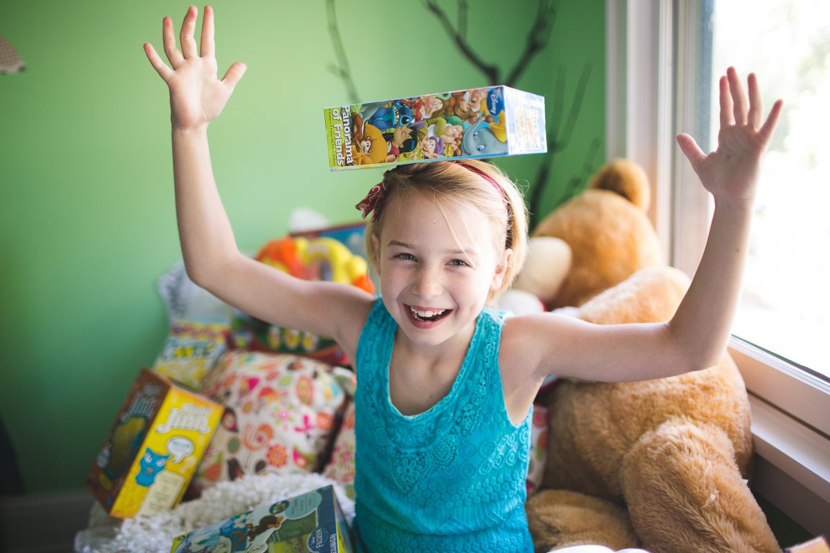 girl balancing box on head