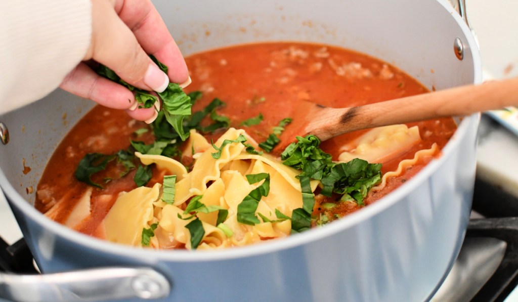 adding basil to lasagna soup