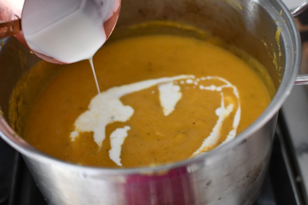 adding cream to butternut squash soup recipe