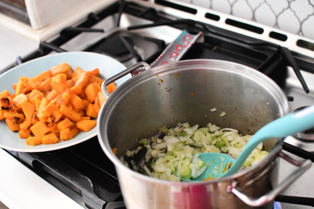 sautéing veggies in a stockpot for butternut squash soup recipe