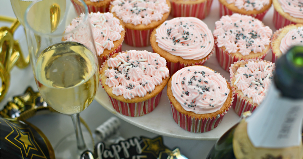 champagne cupcakes on a marble cake stand