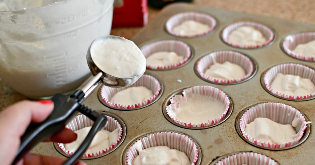 using an ice cream scoop to fill baking pan