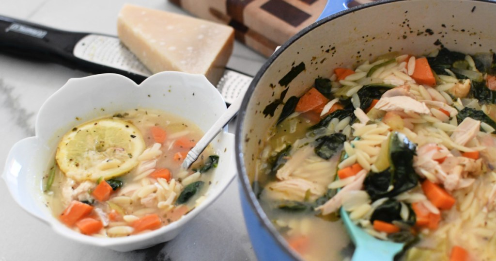 bowl next to pot of chicken lemon orzo soup