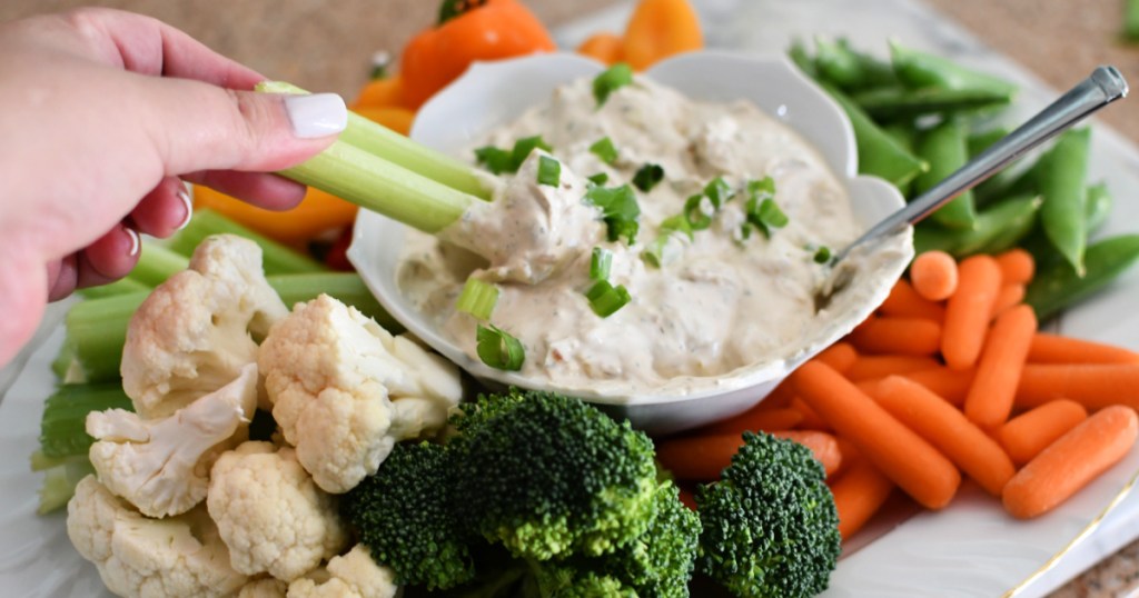 dipping celery into onion dip