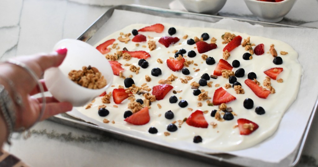 adding granola to frozen yogurt bark