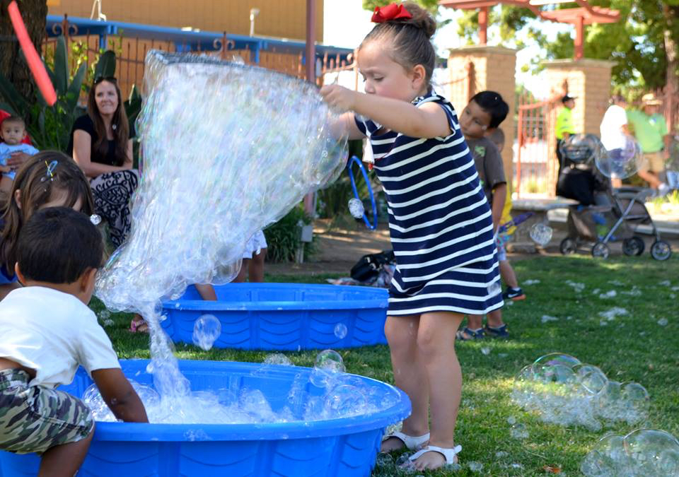 girl playing with bubbles