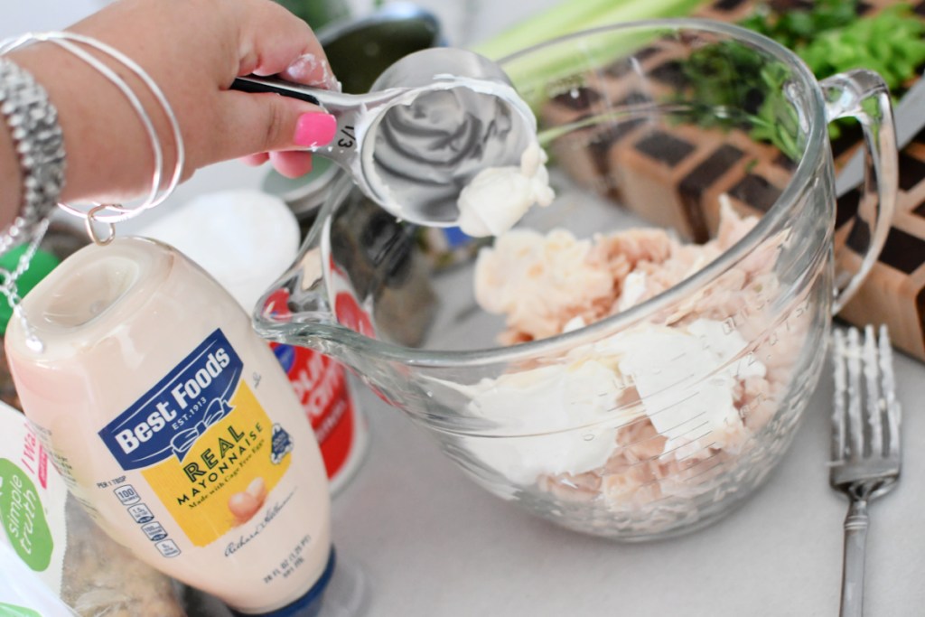 adding sour cream and mayo to chicken salad