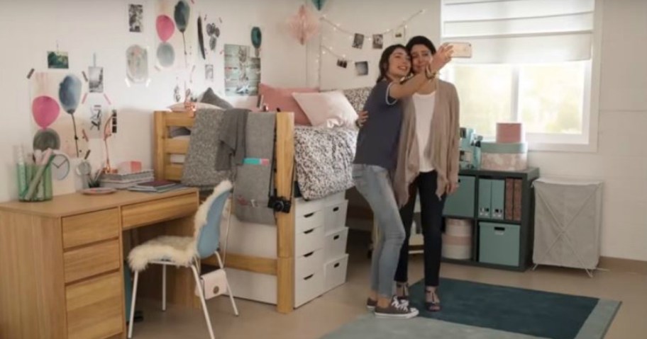 two girls posing in dorm room taking a picture