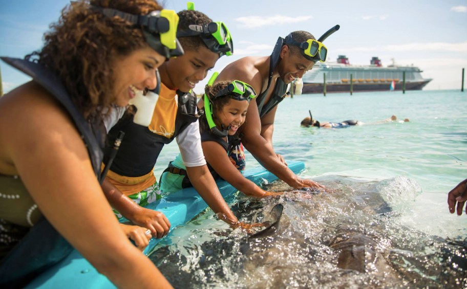 family in the ocean with snorkel gear on