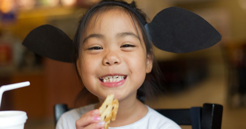 girl wearing cow headband eating Chik-fil-A fry