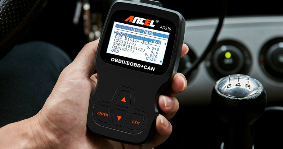 hand holding a diagnostic car code scanner