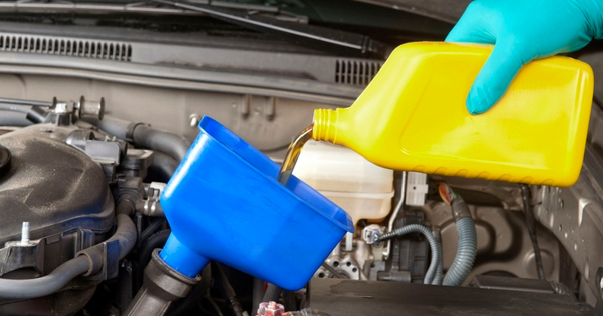 pouring oil into a blue funnel