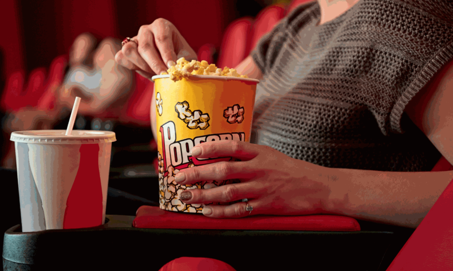 person eating popcorn in theater